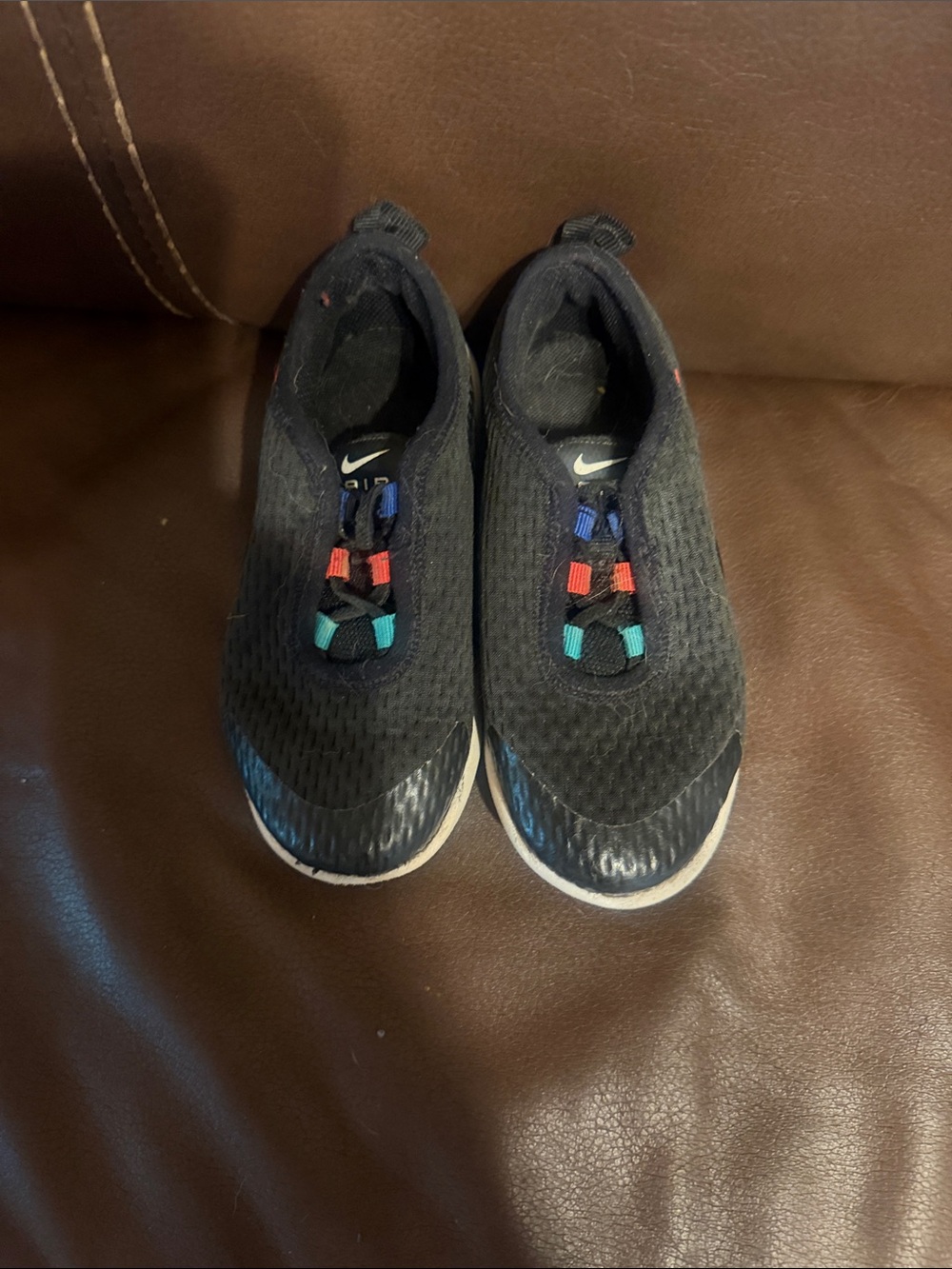 Nike Kids Black Slip-On Sneakers with Blue, Red, and Teal Accents